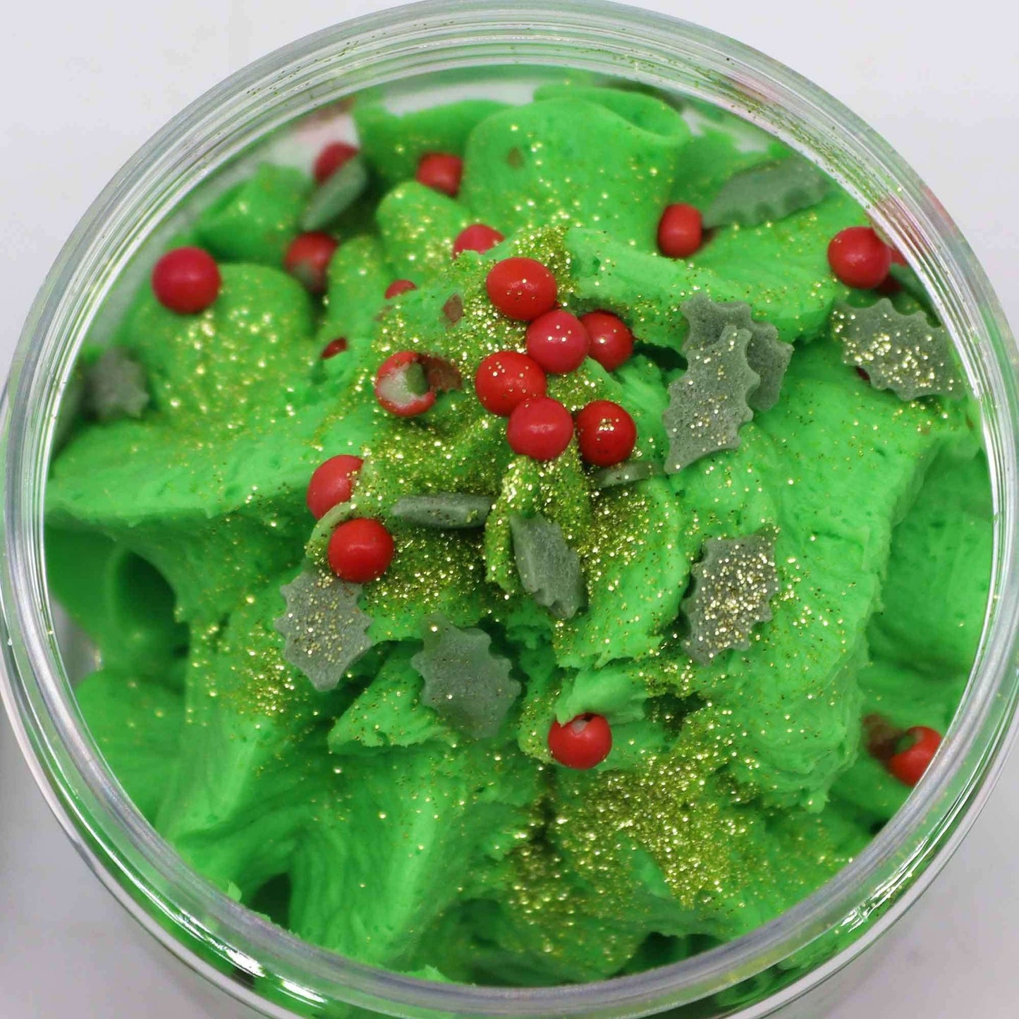 Festive Morning Whipped Soap 120g with green whipped texture, red berry decorations, and gold glitter for a festive shower experience