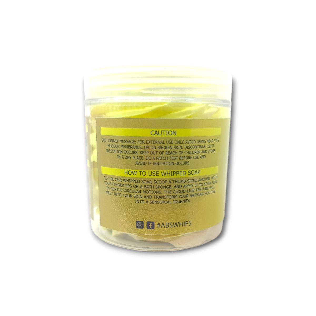Bergamot and Patchouli whipped soap in a clear plastic jar with yellow tinted cream and caution label for external use