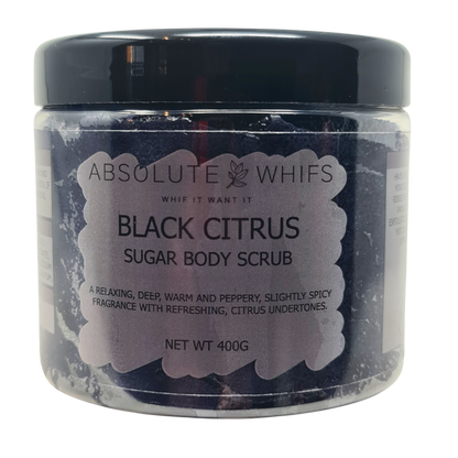Black Citrus Sugar Body Scrub in a clear plastic jar with a black lid, showing dark granular sugar scrub inside and a label with product details