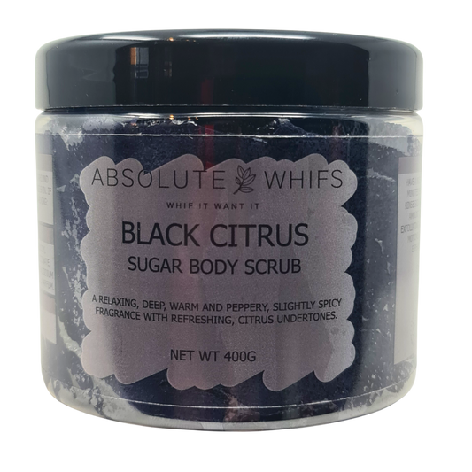Black Citrus Sugar Body Scrub in a clear plastic jar with a black lid, showing dark granular sugar scrub inside and a label with product details