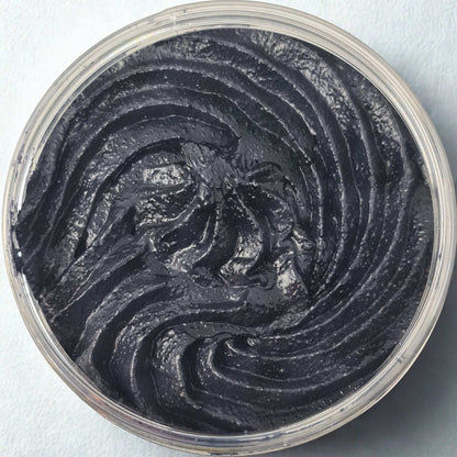 Black Citrus Sugar Body Scrub with rich black, glossy texture and smooth swirled pattern in a clear round container