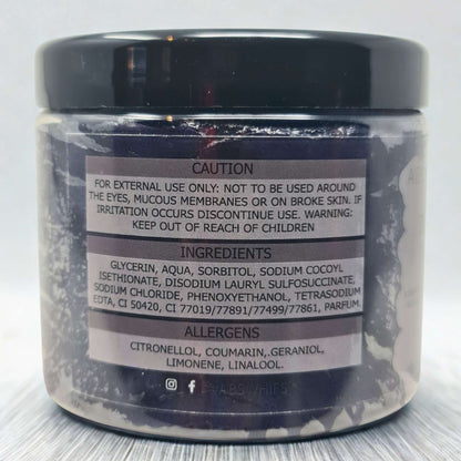 Black Citrus Sugar Body Scrub jar showing caution label, ingredients list, and allergen information on a dark container with black lid