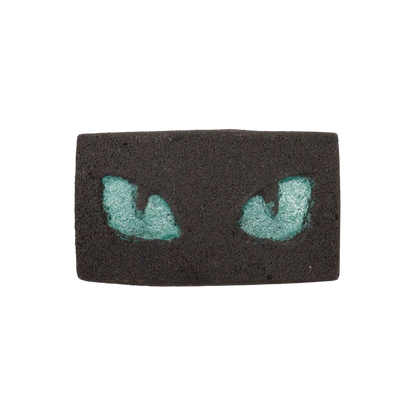 Cats Eyes Halloween Bath Bomb with glowing teal cat eyes in black base