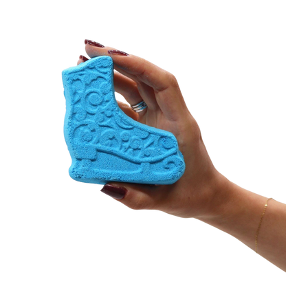 Christmas Fun Bath Bomb Gift Pack featuring a blue bath bomb shaped like an ice skate with embossed details held in a hand