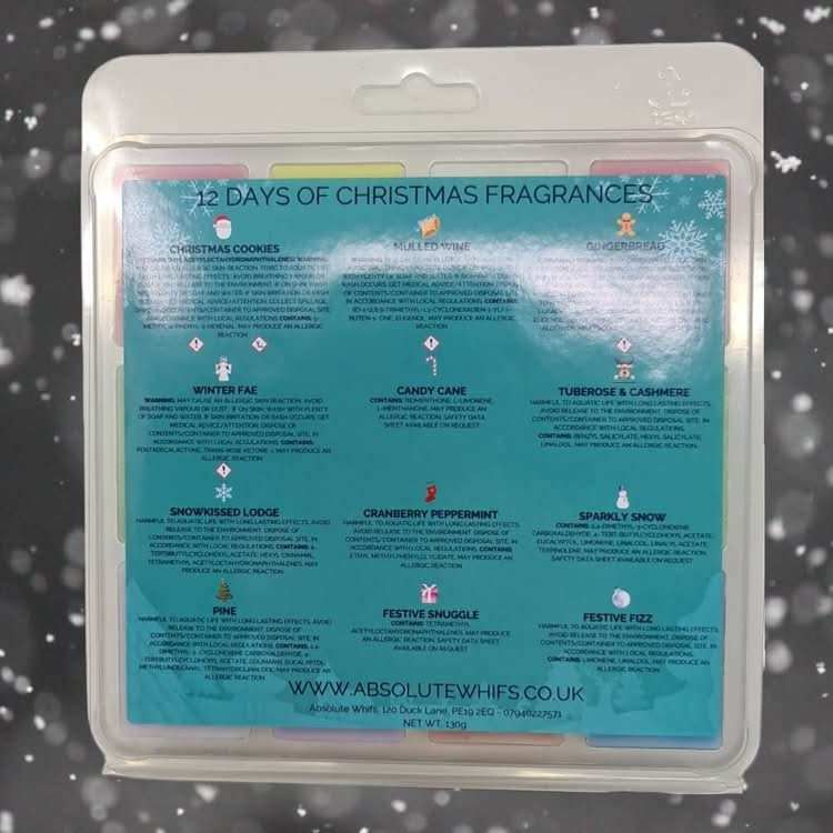 Christmas Wax Melts pack featuring 12 colorful wax cubes with festive scents and descriptive fragrance labels on a teal background