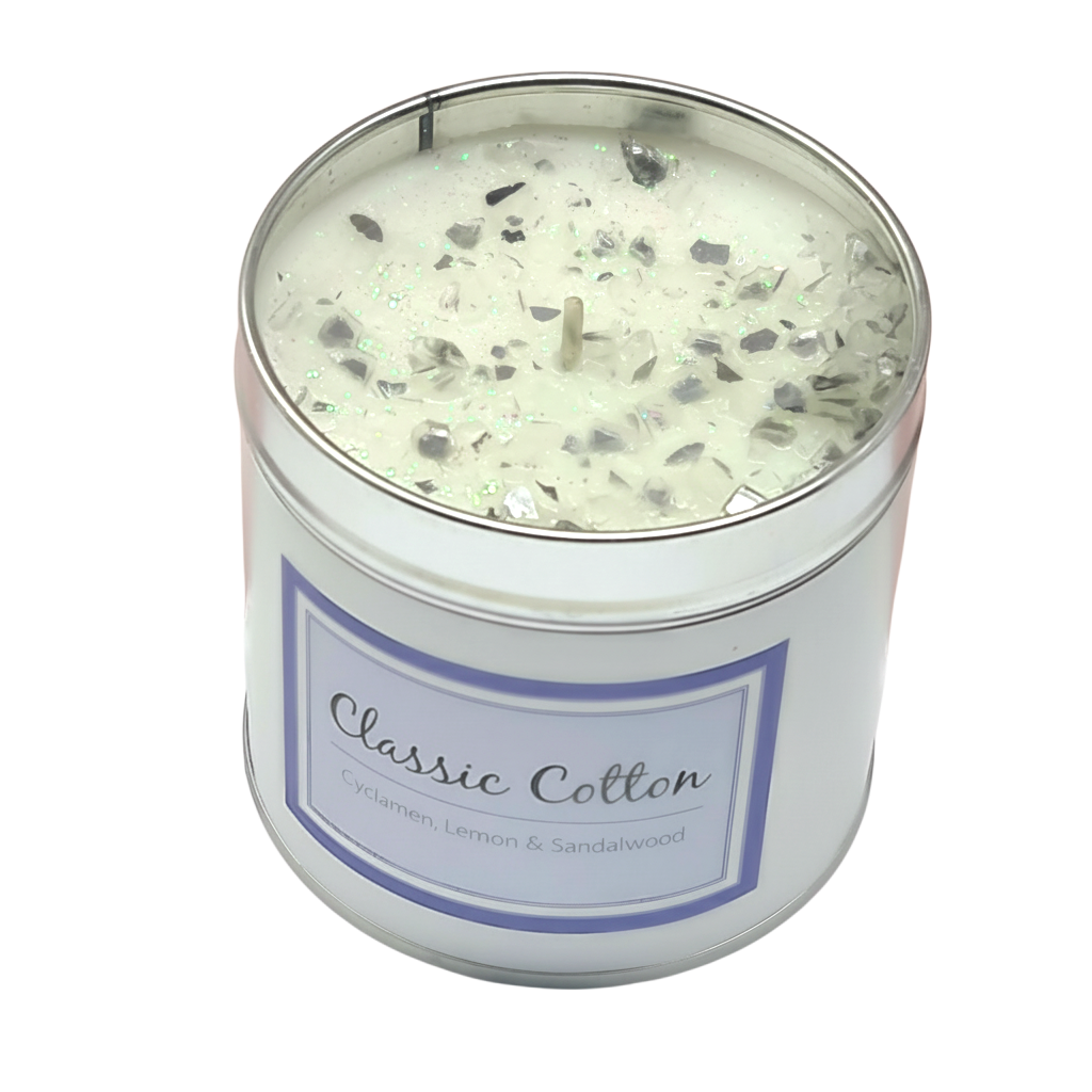 Classic Cotton Seriously Scented Candle in a white container with glittery top and label reading Classic Cotton with scents of cyclamen, lemon, and sandalwood