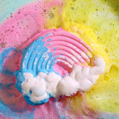 Cloud Bath bomb dissolving with vibrant pink, yellow, and blue foam and a white cloud and rainbow pattern