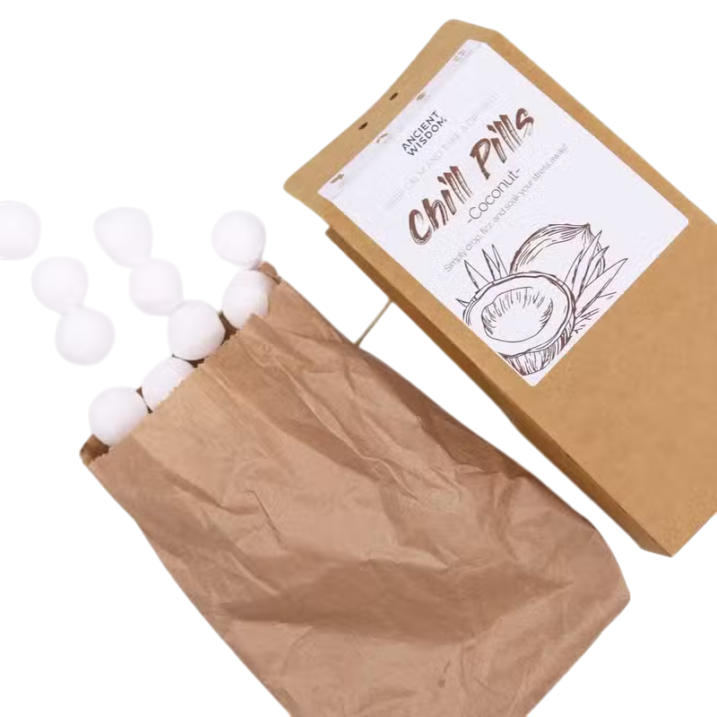 Coconut Chill Pills Gift Pack in brown paper packaging with white coconut-scented bath pills and illustrated label