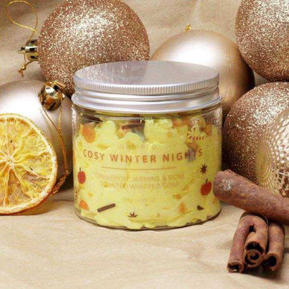 Cosy Winter Nights Whipped Soap in a clear jar with yellow whipped texture, festive fruit pattern and silver lid