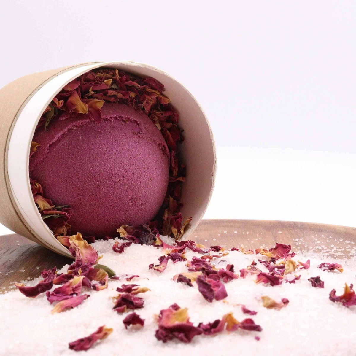 Cupids Self Care Aromatherapy Bath Collection with burgundy bath bomb, white salt, and dried rose petals