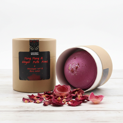 Cupids Self Care Aromatherapy Bath Collection with a burgundy bath bomb, kraft cardboard tube, and dried rose petals