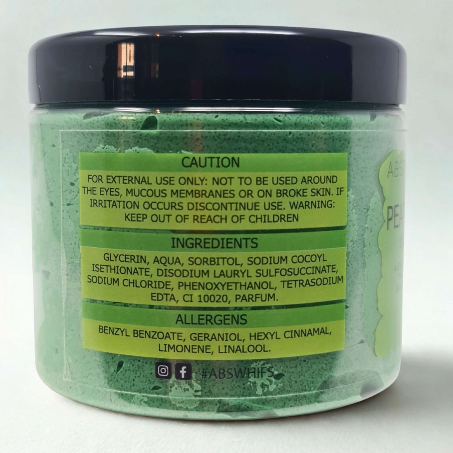 Pear & Freesia Sugar Body Scrub in green jar with black lid showing ingredient and caution labels
