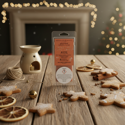 Gingerbread Wax Melt Snap Bar in clear packaging with beige wax burner and festive gingerbread and dried citrus decorations on wooden surface
