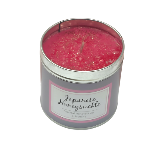 Japanese Honeysuckle Scented Candle in a silver tin with pink wax and sparkly textured surface, labeled with floral scent