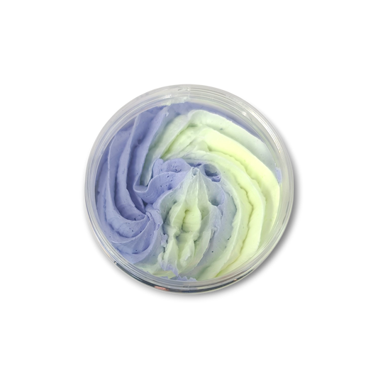 Lemon Lavender Whipped Soap in a transparent jar featuring swirled light purple and pale yellow creamy texture