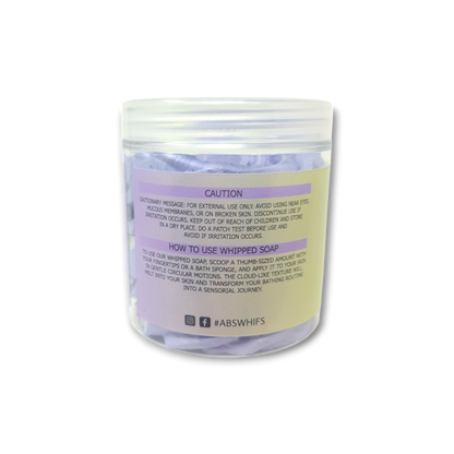 Lemon Lavender Whipped Soap in a transparent jar with pale yellow label and light purple whipped texture visible inside