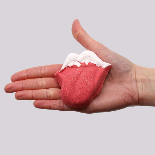 Lips Bath bomb in red with a white foamy top, shaped like puckered lips and sized to fit in a palm