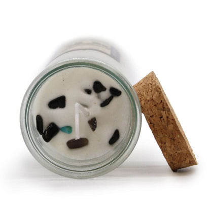 Magic spell candle with black agate gemstones and liquorice scent for luck