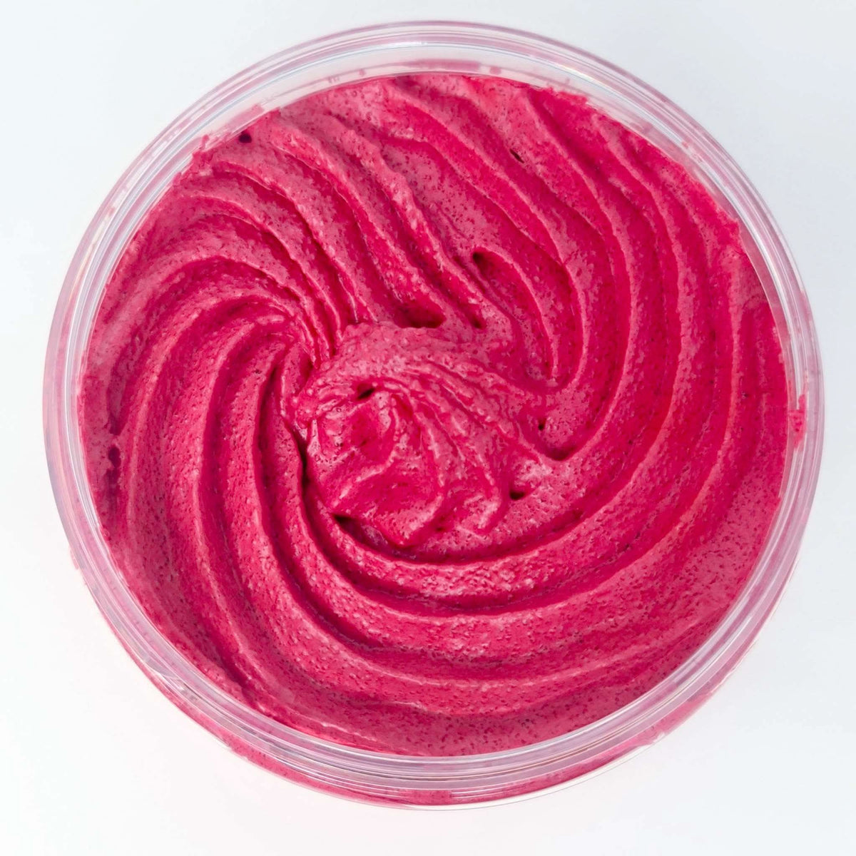 Pomegranate Noir Sugar Body Scrub in a clear container with rich, vibrant pink creamy texture and smooth swirl pattern