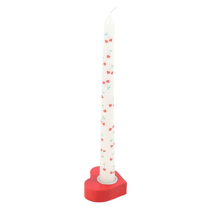 Red heart taper candle holder with a white candle.