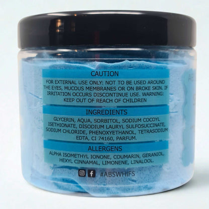 Sea Breeze Sugar Body Scrub in a transparent jar showing blue scrub with caution, ingredients, and allergens labels on the back