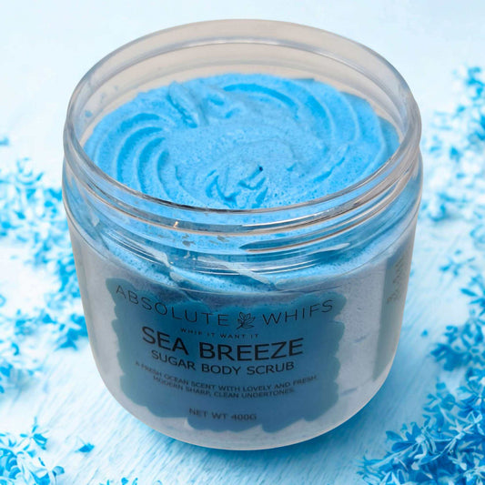 Sea Breeze Sugar Body Scrub in clear jar with vibrant blue whipped texture and smooth swirls inside