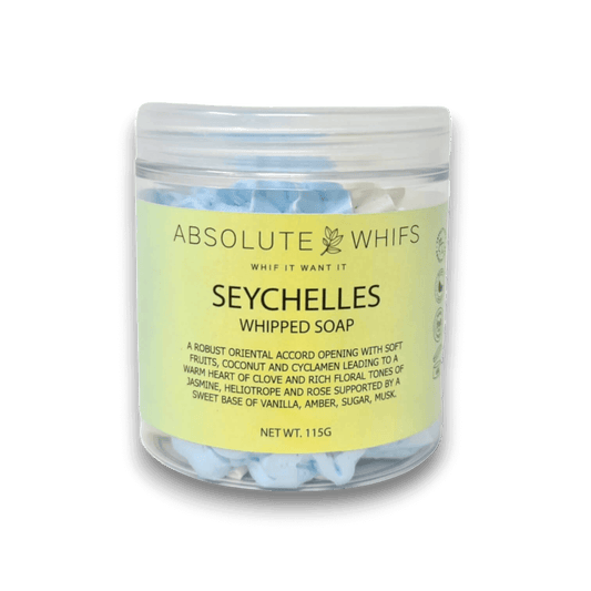 Seychelles Whipped Soap in a transparent jar with light blue whipped soap inside and a yellow label featuring product details