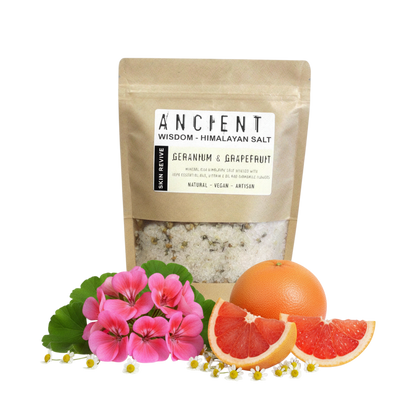 Skin Revive Himalayan Bath Salt in a kraft pouch with white salt, pink flowers, chamomile, grapefruit and whole orange