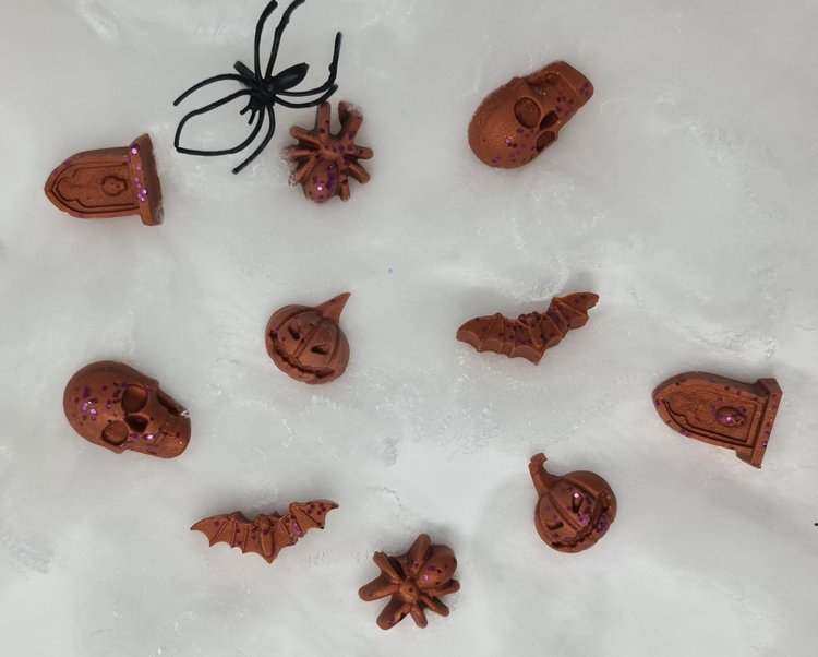 Halloween themed witches truffles wax melts in spooky shapes with brown and purple glitter.