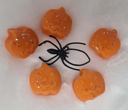 Pumpkin-shaped wax melts with a pumpkin spice fragrance and decorative spider.