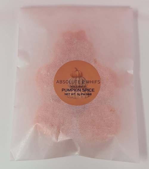 Pumpkin-shaped spiced wax melt with autumn fragrance packaging.