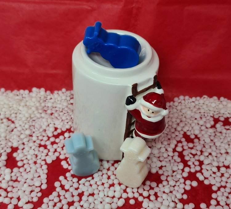 Santa-themed candle holder with snowmen scented wax melts.