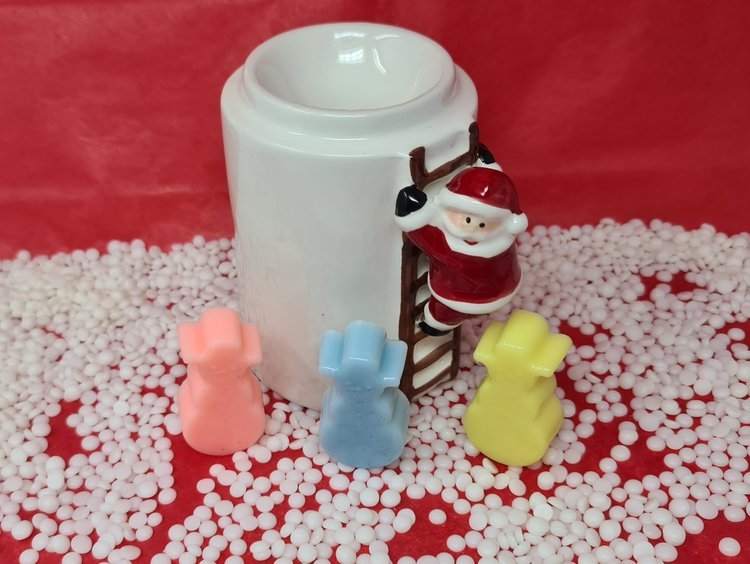 Santa-themed wax melt holder with colorful scented snowmen melts on red and white background.